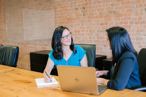 Woman working at desk at home with natural light, focused and calm